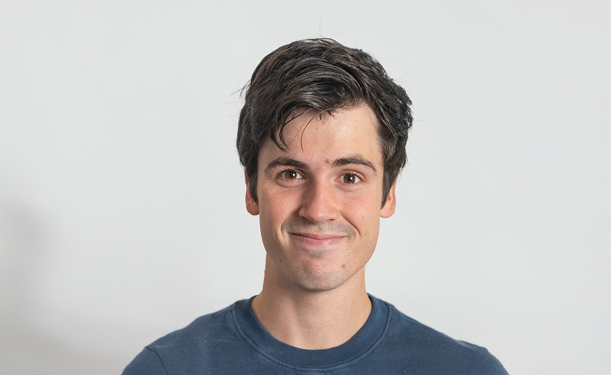 Ung mann ser vennlig inn i kameraet. Portrettbilde