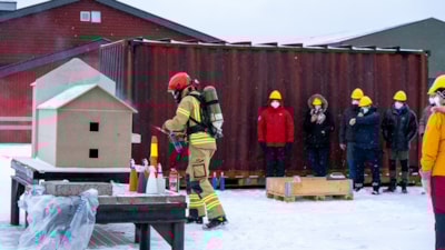 Kursdeltakere observerer rykende modellhus. Foto.