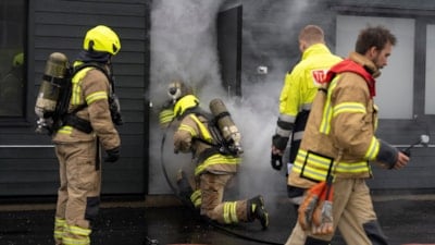 Brannkonstabler går inn i et hus med røyk.